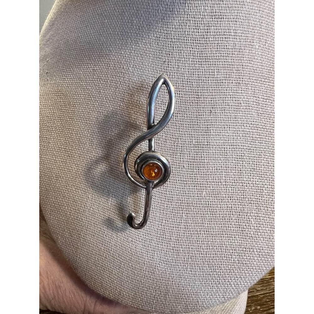 Sterling silver and amber treble clef note pin.